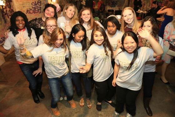 Photo of a group of young women in Chatham University Alumni t-shirts, posing for the camera